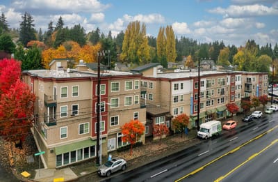 Exterior view of the senior living facility with trees in fall colors