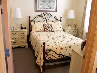 Cozy resident room with a patterned bedspread and lamps