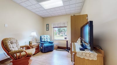 Cozy resident room with seating and television