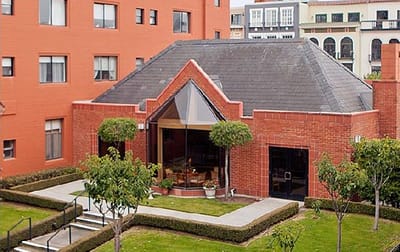 Exterior view of a senior living building with landscaped area