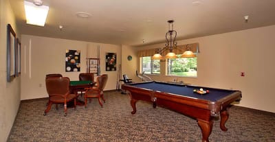 Common area with a pool table and card table