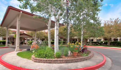 Exterior view of facility entrance with garden landscaping