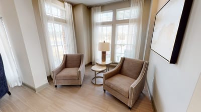 Interior seating area with two chairs and a lamp