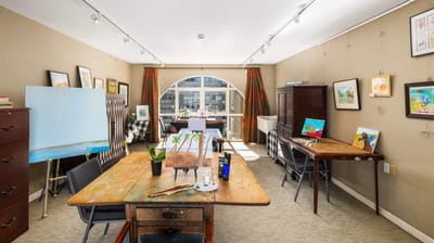 Art studio with tables and paintings on display