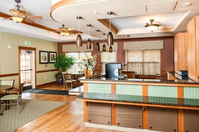 Bright common area with seating and a service counter