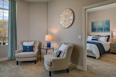 Cozy resident room with seating area and artwork