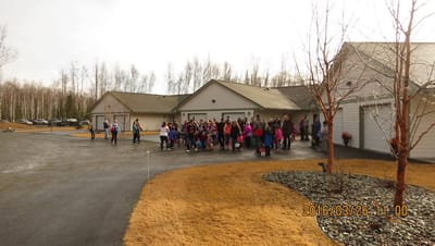 Group of people gathered outside the facility