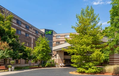 Exterior view of The Montclair with trees and entrance