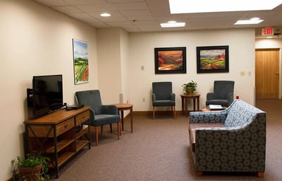 Bright common area with comfortable seating and artwork