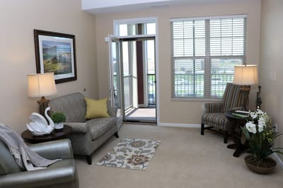 Cozy sitting area in a resident room with balcony access