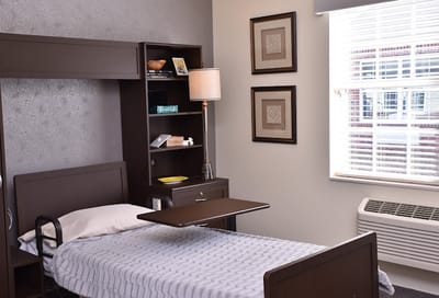 A private resident room with a hospital bed and decorations