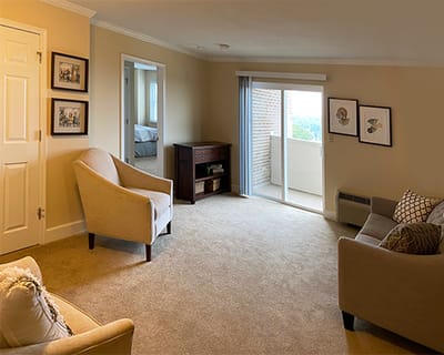 Bright living room with balcony access and cozy furniture