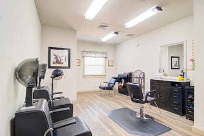 Hair salon area with styling chairs and mirrors