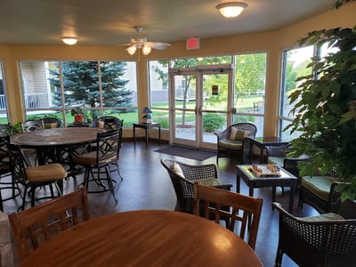 Bright common area with seating and access to outdoor space