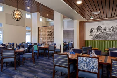 Bright and modern dining area with tables set for meals