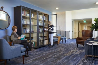 Residents enjoying a cozy reading area in a common room