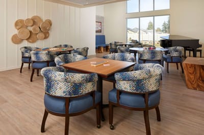 Bright interior common area with patterned chairs and tables