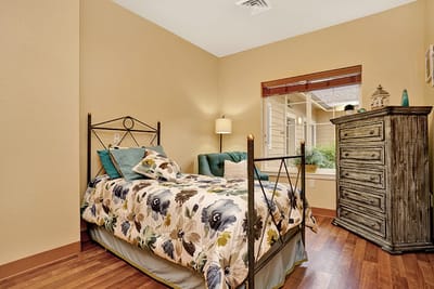 Cozy private room with a bed and armchair