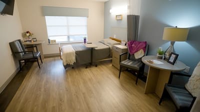 Cozy resident room with a bed and seating area