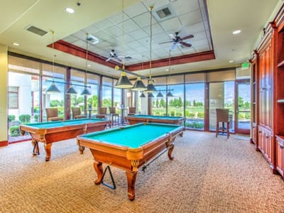 Engaging game room with pool tables and natural light