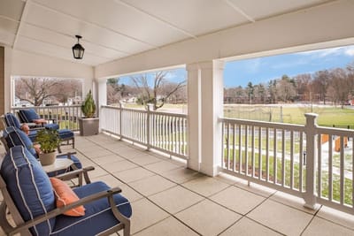 Outdoor seating area with comfortable chairs overlooking a garden