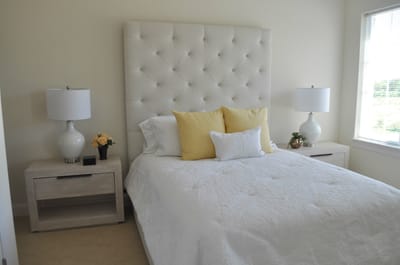 Cozy bedroom with two lamps and decorative pillows