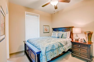 Cozy resident bedroom with a queen bed and decor
