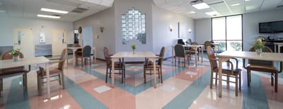 Bright dining room with tables set for meals