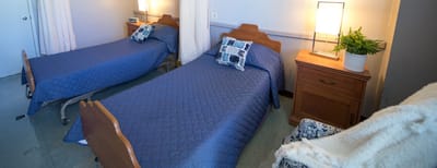 Shared resident room with two beds and bedside tables