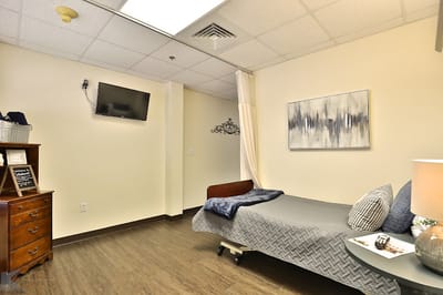 A private resident room with a bed and decor