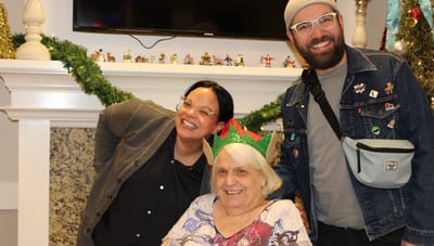 Three people celebrating in a common area.