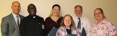 Group photo of staff members smiling together