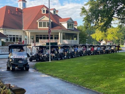 Golf carts lined up outside a facility