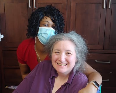 Staff member with resident smiling together