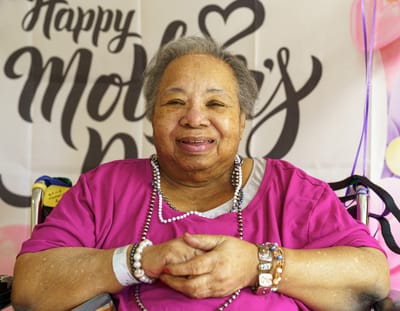 Resident smiling during Mother's Day celebration
