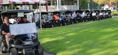 Golf carts lined up outside a facility