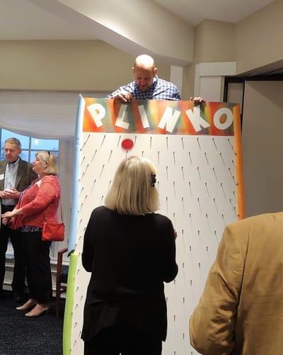 Residents participating in a Plinko game