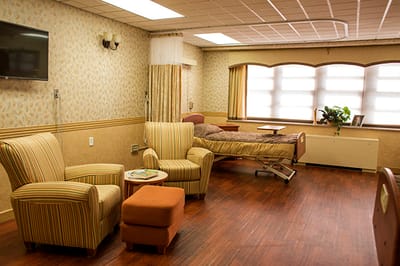 Private resident room with seating and bed