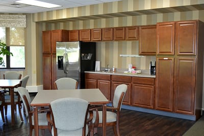 Common area with kitchenette and dining tables.