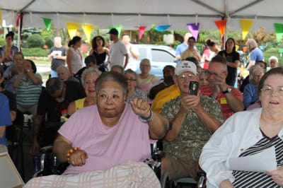 Residents enjoying a community celebration outdoors.