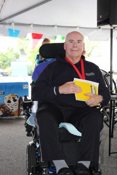 Resident in a powered wheelchair at an event