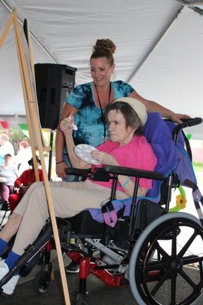 Staff assisting a resident during an art activity