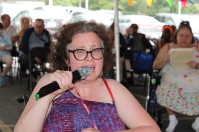 Resident singing at a community event.