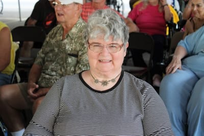 Smiling resident at an outdoor gathering