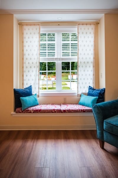 Cozy seating area by a window with cushions