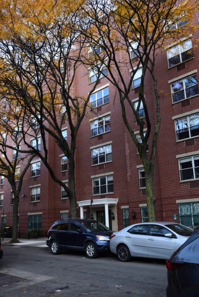 Exterior view of Ridge Street Gardens building with trees