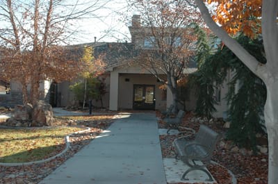 Pathway leading to the entrance of the facility surrounded by trees