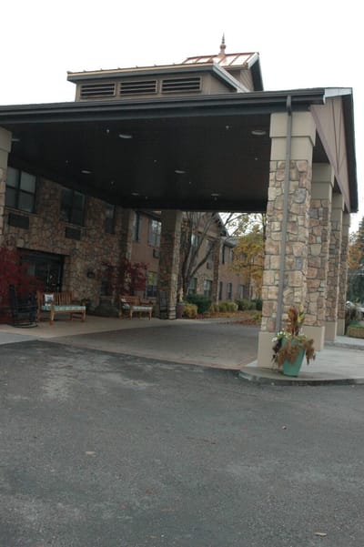 Entrance of a senior living facility with stone architecture