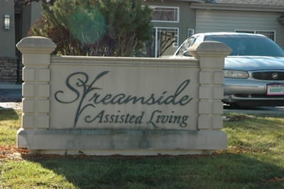 Streamside Assisted Living facility logo on a stone sign