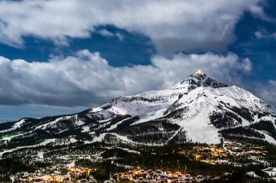 A snow-covered mountain under a cloudy sky